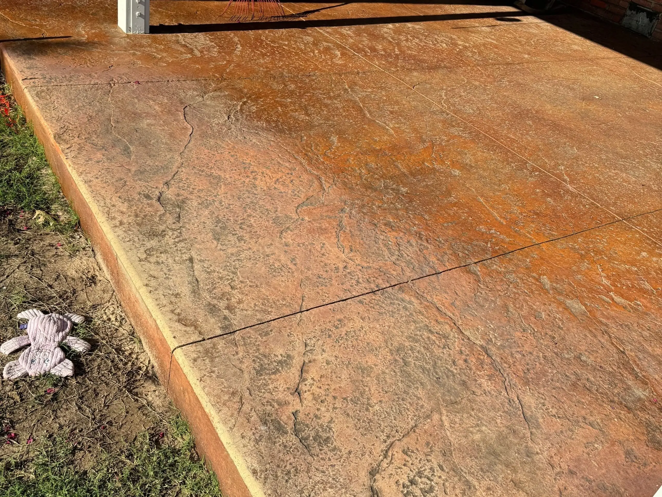 Stamped concrete patio with a textured stone pattern and tan color finish