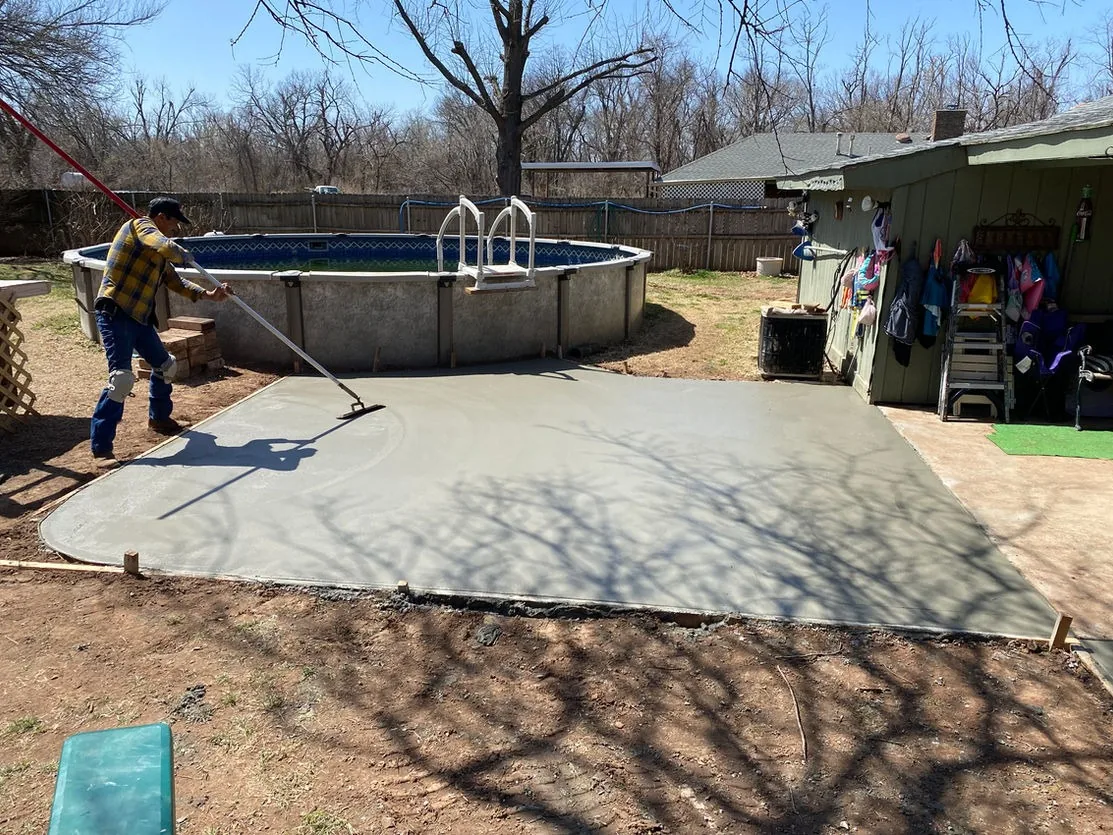 New concrete slab poured beside a backyard pool in Phoenix, AZ