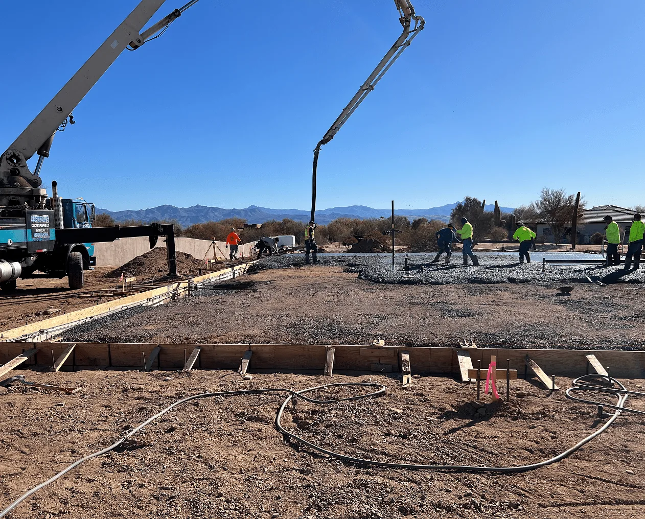 Concrete pump truck placing a residential foundation over rebar and forms in Phoenix, AZ